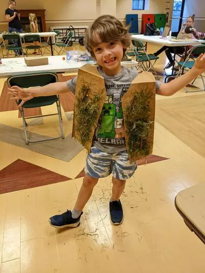 photo of a child with their camouflage craft