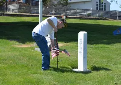 veteran placing flag