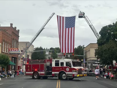 Ladder truck with American flag on Main Street