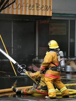 eagles_fire_fighting.jpg Firefighters blast a burning building with water from a high pressure fire hose