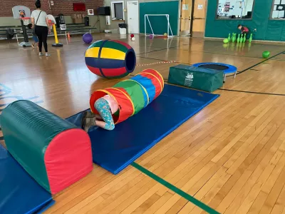kid climbing through tunnel