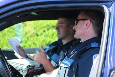 fto-photo.jpg Officers reviewing paperwork in a patrol car